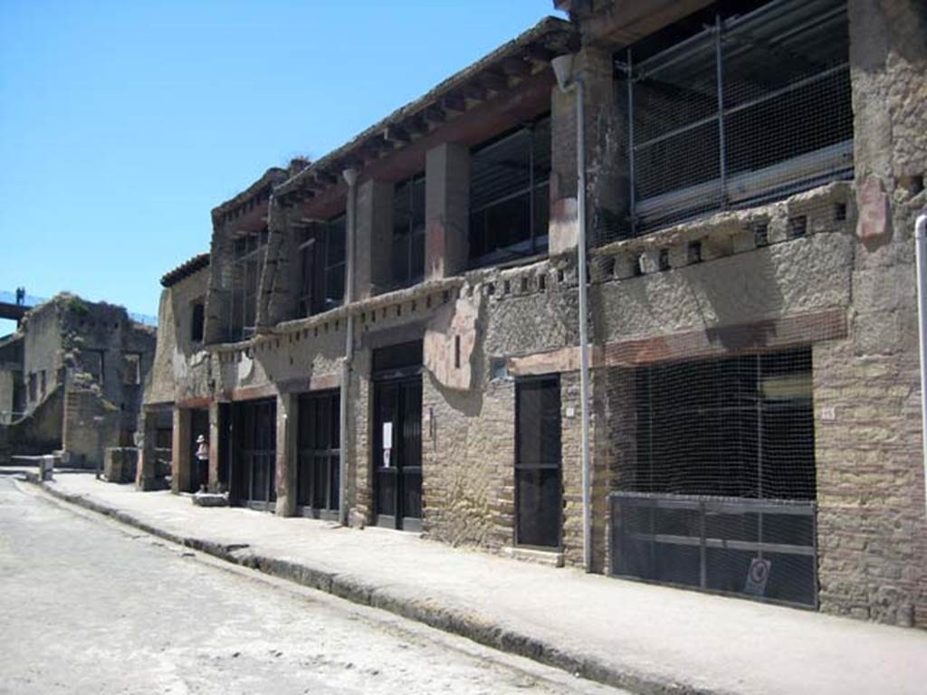 Decumanus Maximus, south side, Herculaneum, June 2011. Looking east along north side of Insula V.
The doorway to V.15 is the taller one in the centre of the photo.  Photo courtesy of Sera Baker.